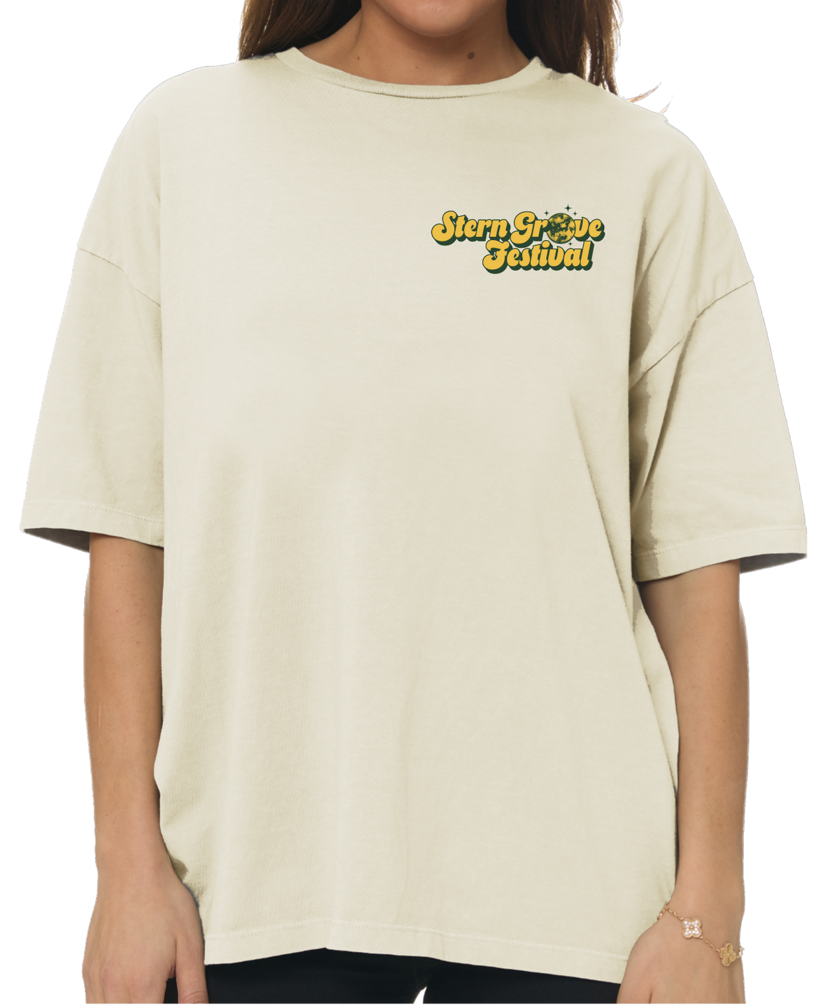 A person wearing an oversized cream-colored t-shirt with a yellow and black 'Stay Freeze School' graphic on the left chest, shown against a plain white background.